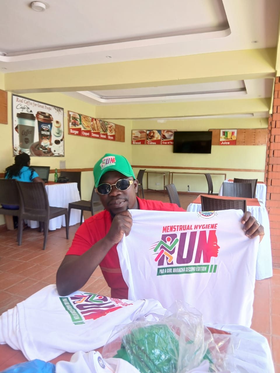 Participant displaying a menstrual hygiene run shirt